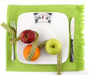 Diet concept. Fruits with measuring tape  on a plate like weight scale