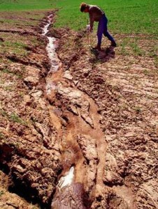 The picture shows how soil gets eroded through natural resources, as river.